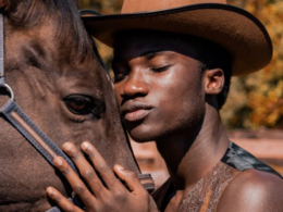 Man with face resting on horse's head