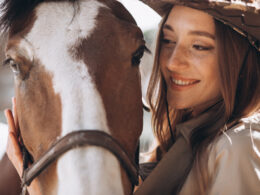 Woman smiling at horse