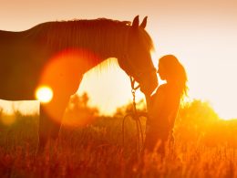 Woman with horse at sunset